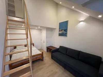 a living room with a couch and a bunk bed at Duplex sympa Verviers in Verviers
