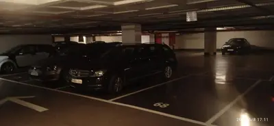 a parking garage with two cars parked in it at Liège centre Médiacité appartement possible parking terrasse immense 8ème pour 2 personnes in Liège