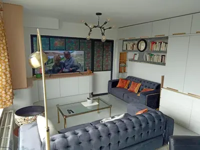 a living room with two blue couches and a table at Liège centre Médiacité appartement possible parking terrasse immense 8ème pour 2 personnes in Liège
