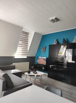 a living room with a couch and a table at Escale in Liège