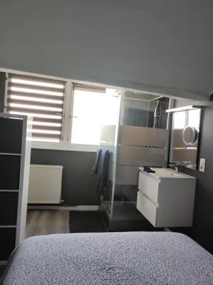 a bedroom with a bed and a sink and a window at Escale in Liège