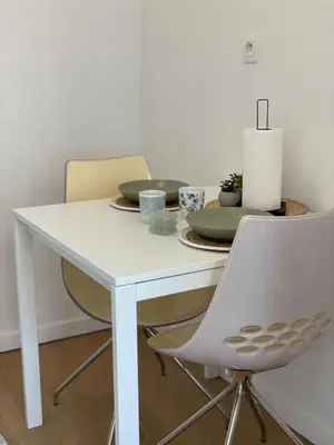 a white dining room table with two chairs and a table at St Catherine in Liège