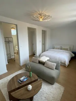 a living room with a bed and a couch at St Catherine in Liège