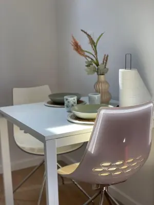 a dining room table with a chair and a white table at St Catherine in Liège