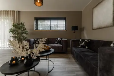 a living room with a couch and a table at Luxury house 