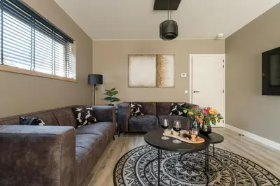 a living room with a couch and a table at Luxury house 