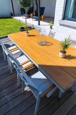 a wooden table with two chairs on a deck at Garden Guillemins Station in Liège