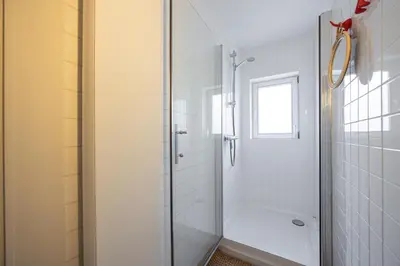 a bathroom with a shower with a glass door at Het Generaaltje in Hasselt