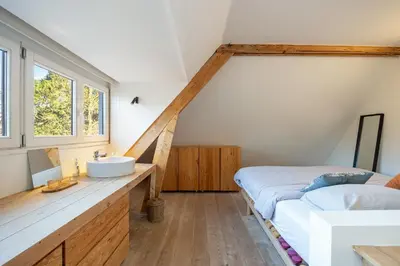 a bathroom with a sink and a bed in a room at Het Generaaltje in Hasselt