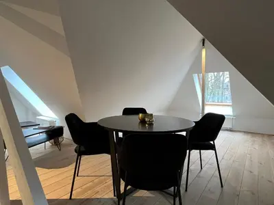 a dining room with a table and black chairs at Het Generaaltje in Hasselt