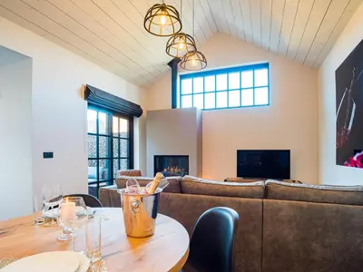 a room with a table with chairs and a couch at Welldone Resort / Cozy Wine in Nieuwerkerken