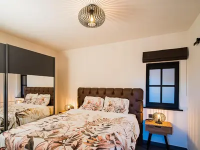 a bedroom with two beds and a mirror at Welldone Resort / Cozy Wine in Nieuwerkerken