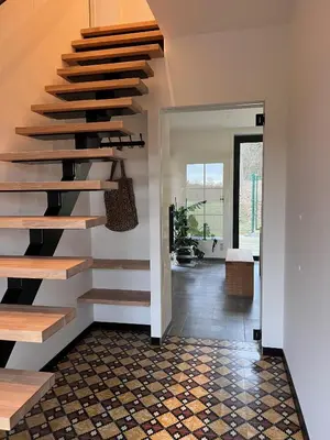 a staircase in a home with aoyer with a tile floor at De Bovenbuur in Lummen