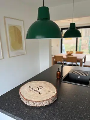 a wooden cutting board sitting on top of a counter at De Bovenbuur in Lummen