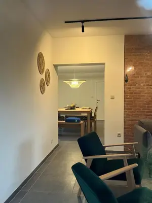 a dining room with a table and chairs at De Bovenbuur in Lummen