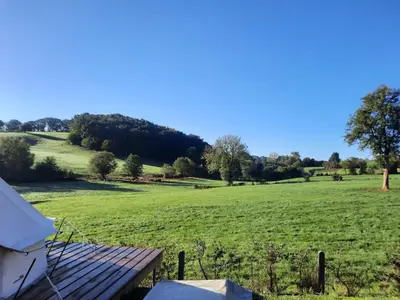 a view of a field from a tent at Le Bunker du Houyeux in Herve