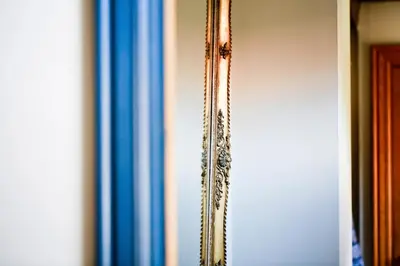 a mirror hanging on a wall in a room at Côté cour, côté source chambre d'hôtes in Chaudfontaine