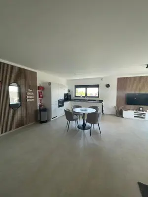 a kitchen and dining room with a table and chairs at Casa 47 in Eupen