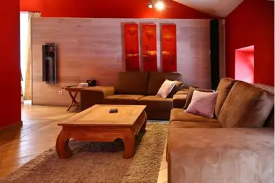 a living room with a couch and a coffee table at Jacuzzi - BBq - Jardin - Garden Lodge - Le Tulipier in Olne