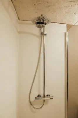 a shower head hanging from a ceiling in a bathroom at L'Orée du Bois by WelcHome in Verviers