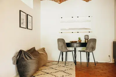 a dining room with a table and two chairs at L'Orée du Bois by WelcHome in Verviers