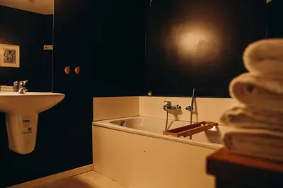a bathroom with a sink and a bath tub next to a sink at Liège City by WelcHome in Liège