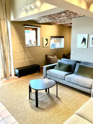a living room with a couch and a coffee table at Le Val du Cossart by WelcHome in Verviers