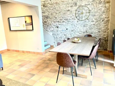 a dining room with a wooden table and chairs at Le Val du Cossart by WelcHome in Verviers