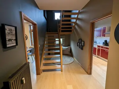 a spiral staircase in a room with a kitchen at Le Voisin du Pré by WelcHome in Verviers