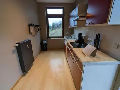 a kitchen with a counter and a sink and a window at Le Voisin du Pré by WelcHome in Verviers