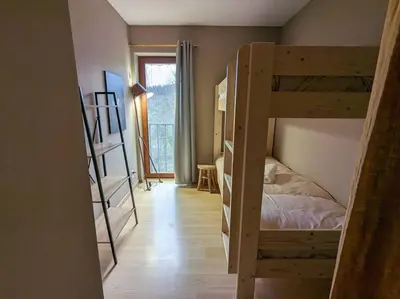 a room with two bunk beds and a hallway at Le Voisin du Pré by WelcHome in Verviers