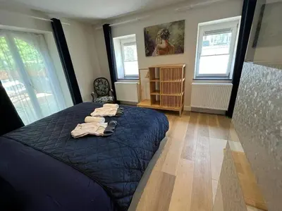 a bedroom with a bed with towels on it at Jacuzzi - Sauna - BBq - Jardin - Garden Lodge - Myosotis in Olne