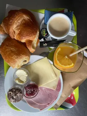 a plate of food with bread and a cup of coffee at Homestay La Montagne des Coeurs in Eigenbilzen