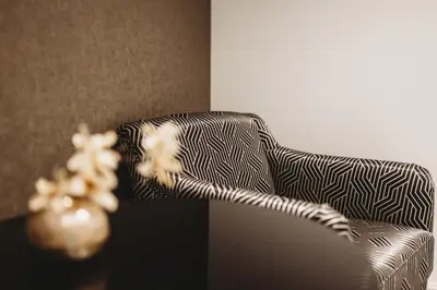 a cat is sitting on a chair in a room at Eikenhoef in Lommel