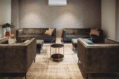 a lobby with couches and tables in a room at Eikenhoef in Lommel