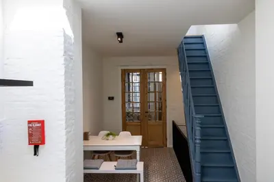 a staircase leading up to a room with a door at Huys17 in Hasselt