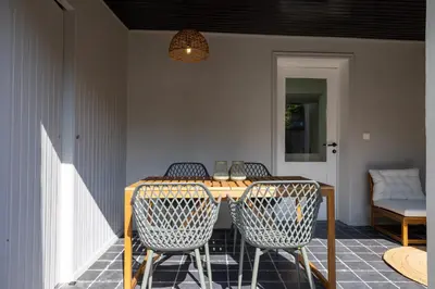 a dining room table with chairs and a lamp at Huys17 in Hasselt