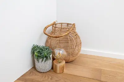 a wicker basket and a potted plant on a floor at Huys17 in Hasselt