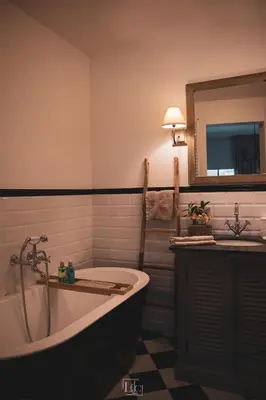 a bathroom with a bath tub and a sink at La Forteresse in Borgloon