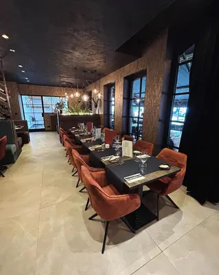 a dining room with a long table and chairs at La Forteresse in Borgloon