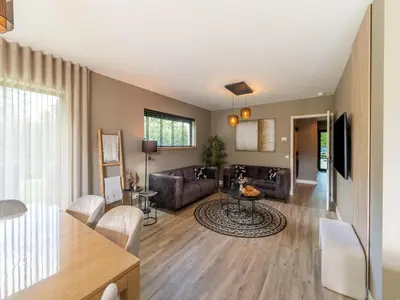 a living room with a couch and a table at Beaunita Luxe Stay in Hamont in Hamont-Achel