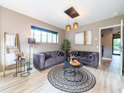 a living room with a couch and a table at Beaunita Luxe Stay in Hamont in Hamont-Achel