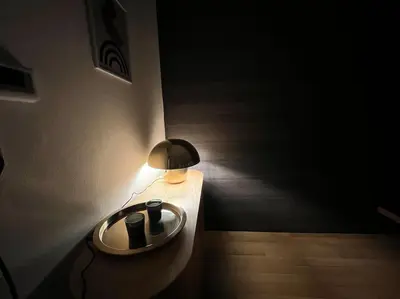 a lamp on a table in a room at Bellevue - Grand appartement pour 5 sur les quais de la Meuse in Liège