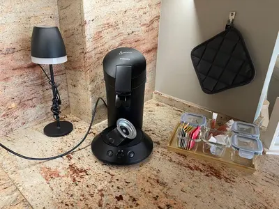 a hair dryer sitting on a counter next to a lamp at Apart Loten in Eupen