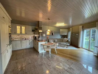 a kitchen and living room with a table and chairs at Apart Loten in Eupen