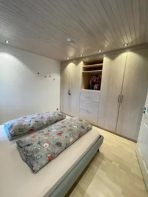 a bedroom with a bed with a pillow on it at Apart Loten in Eupen