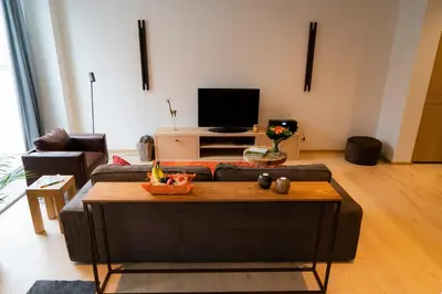 a living room with a couch and a table at Cheval Blanc - Holiday Rental in Aubel