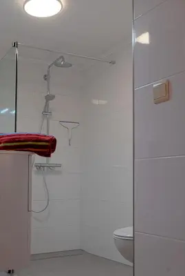 a glass shower in a bathroom with a toilet at Ferienwohnung An den Linden in Kelmis