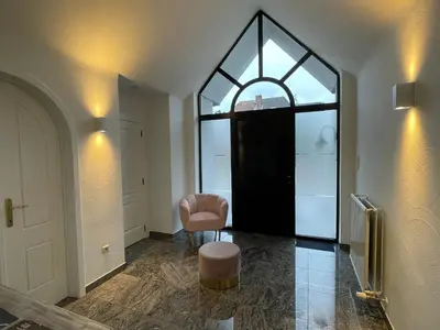 a room with a window and a chair and a door at Vakantiewoning Villa 35 in Maasmechelen