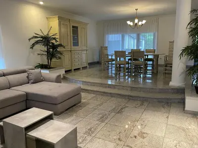 a living room with a couch and a dining room at Vakantiewoning Villa 35 in Maasmechelen